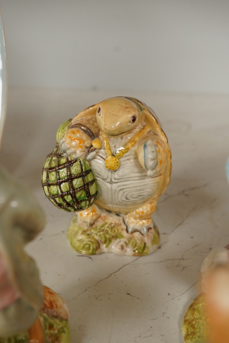 A collection of Beswick and Royal Albert Beatrix Potter figures to include Little Black Rabbit and The Head Gardener, together with two plates, 19cm wide